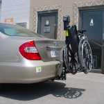 TRILIFT Ultra Lite carrying a manual wheelchair on a Toyota Camry.